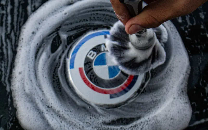Detailer polishing a BMW by hand
