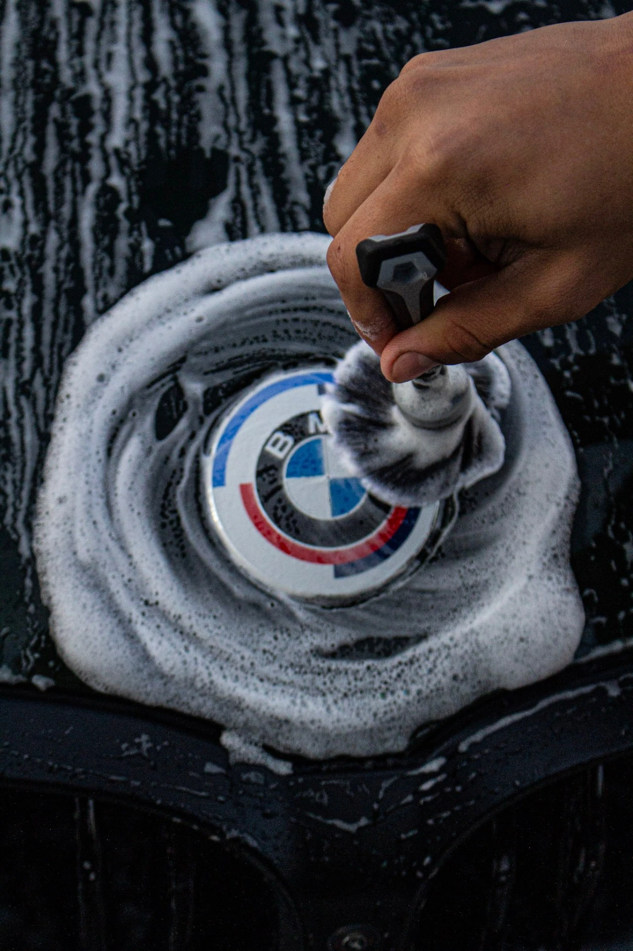 BMW badge detail brush cleaning Tri-Cities WA - meticulous hand wash and foam application
